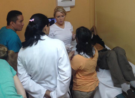 Christina Hendricks speaking to a patient with observers