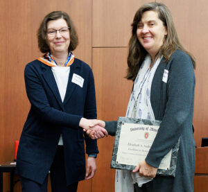 Elizabeth Sadowski, MD, accepts the 2024 Excellence in Mentorship Award from Cherri Hobgood, MD.