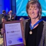 Elizabeth Burnside holding the Gold Medal Award she received from the Radiological Society of North America.