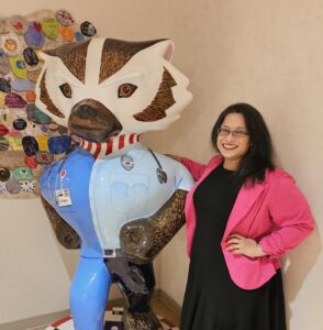 Dr. D'Souza poses with a Bucky Badger statue.