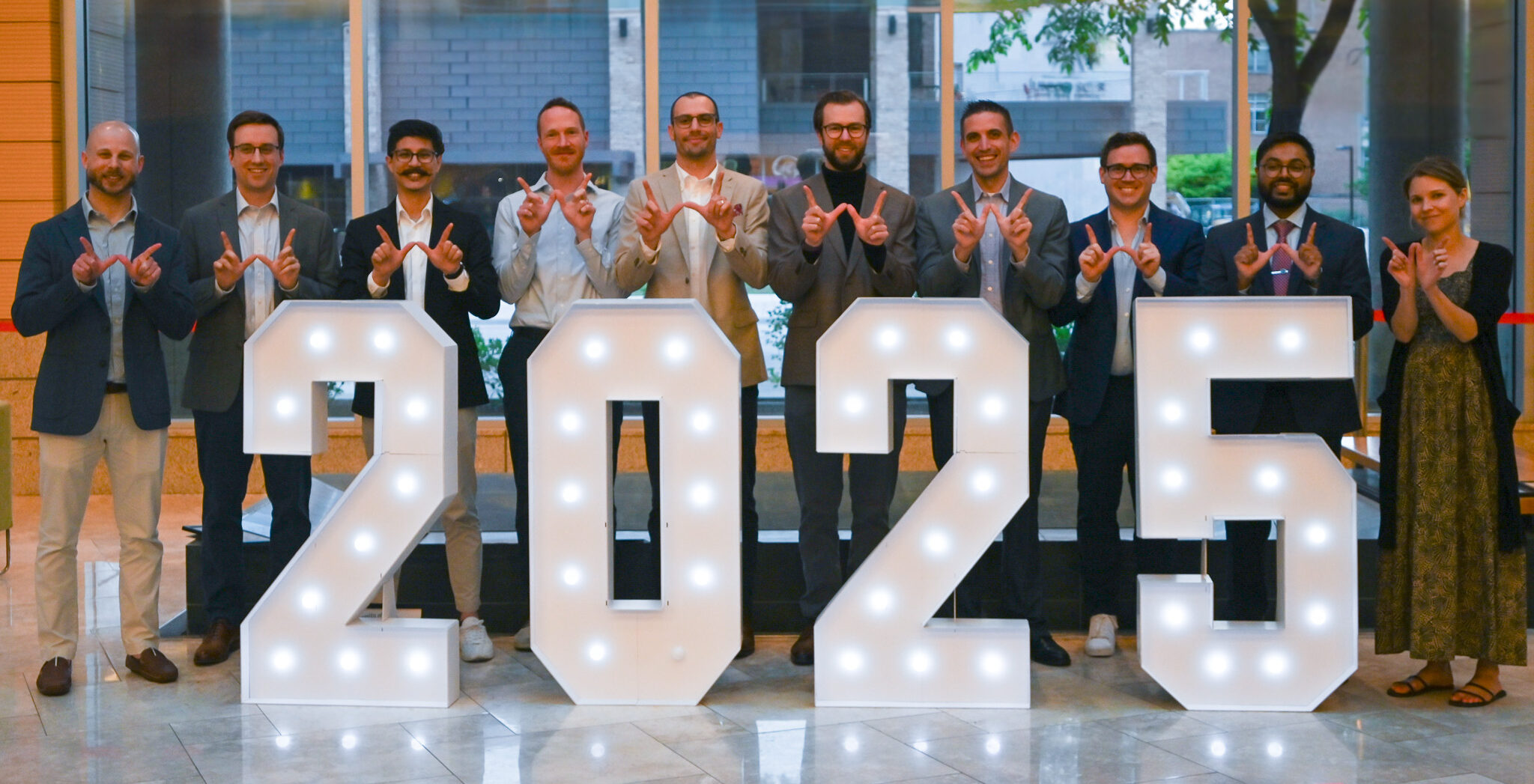 Graduates pose with a 2025 sign.