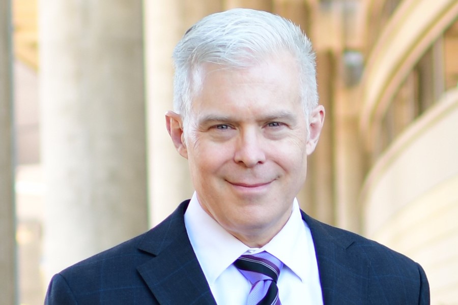 Image of a man dressed in a suit and tie.