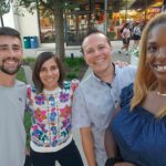 Four people pose together.