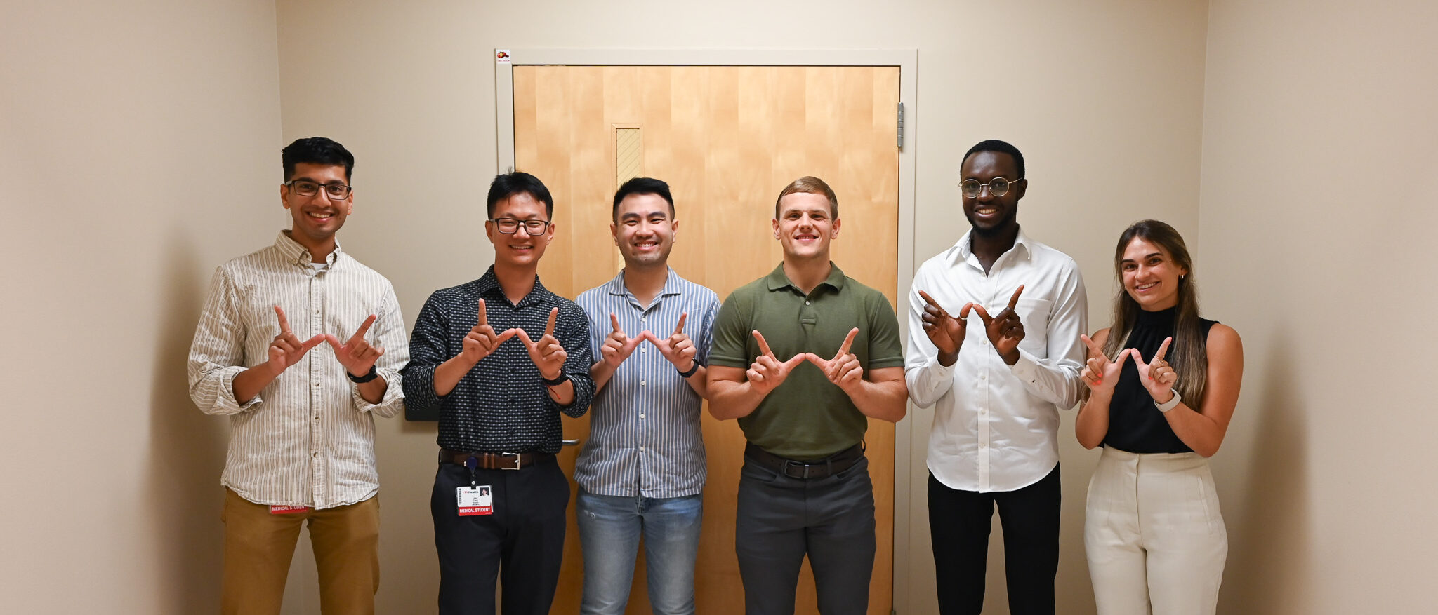 The summer research students pose together for a photo. The group includes six students. 